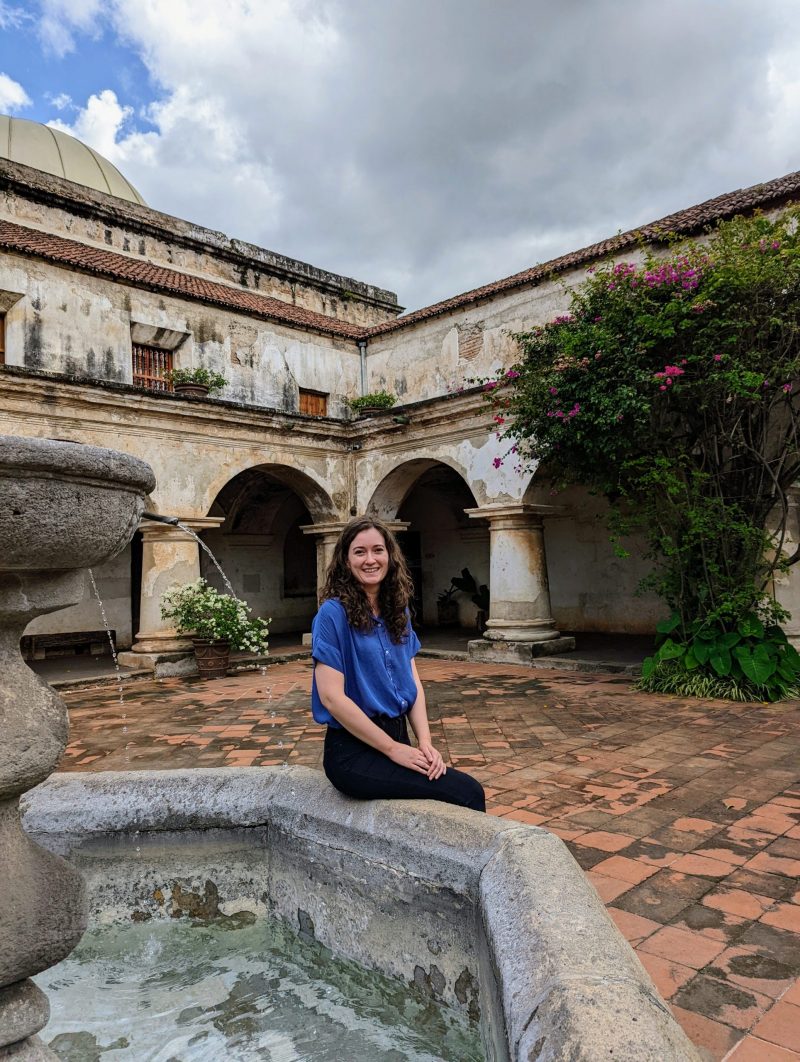 Jessica sitting on the edge of the fountain in the Iglesia y Convento de Las Capuchinas