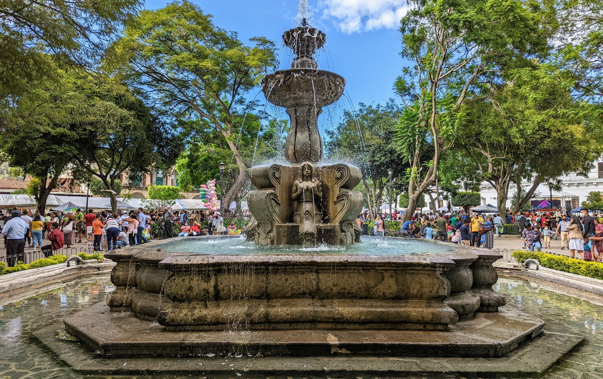 Picture of the fountain in Antigua Central Park. People are seen in the background.