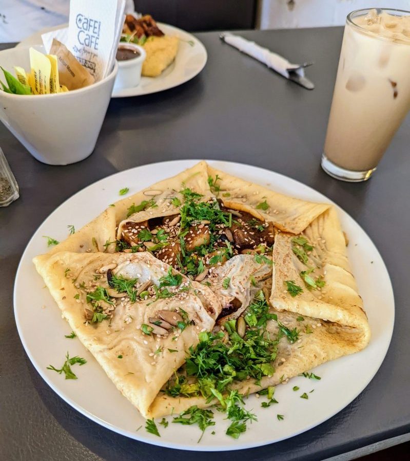 Photo of vegan pepian. A traditional guatemalan stew inside a rice based crepe. 