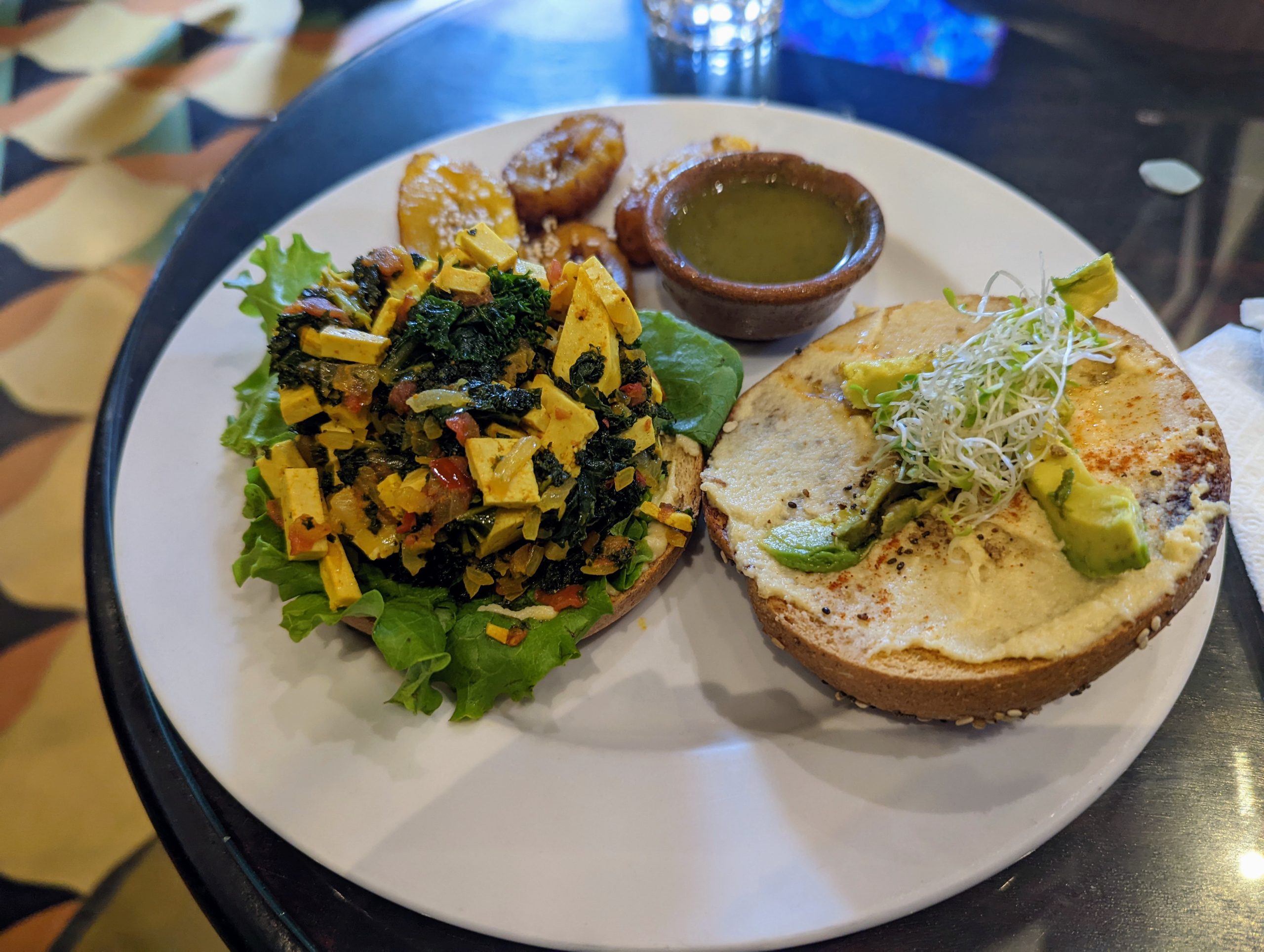 A vegan breakfast bagel, open face.