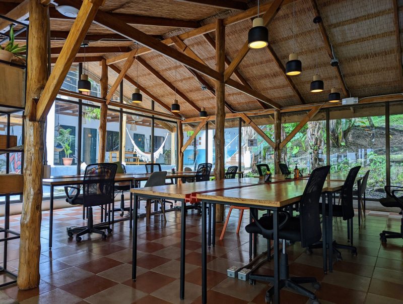 Several work tables and office chairs in a room. 